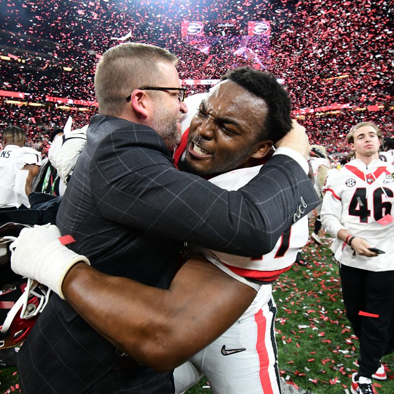 J. Reid Parker Director of Athletics John Brooks and Nakobe Dean (17) of the Bulldog football team after playing against the Crimson Tide from the University of Alabama, in the 2021 College Football Playoff Championship game, played at Lucas Oil Stadium, in Indianapolis, IN. Photo credit Perry McIntyre/UGA Sports Communications.