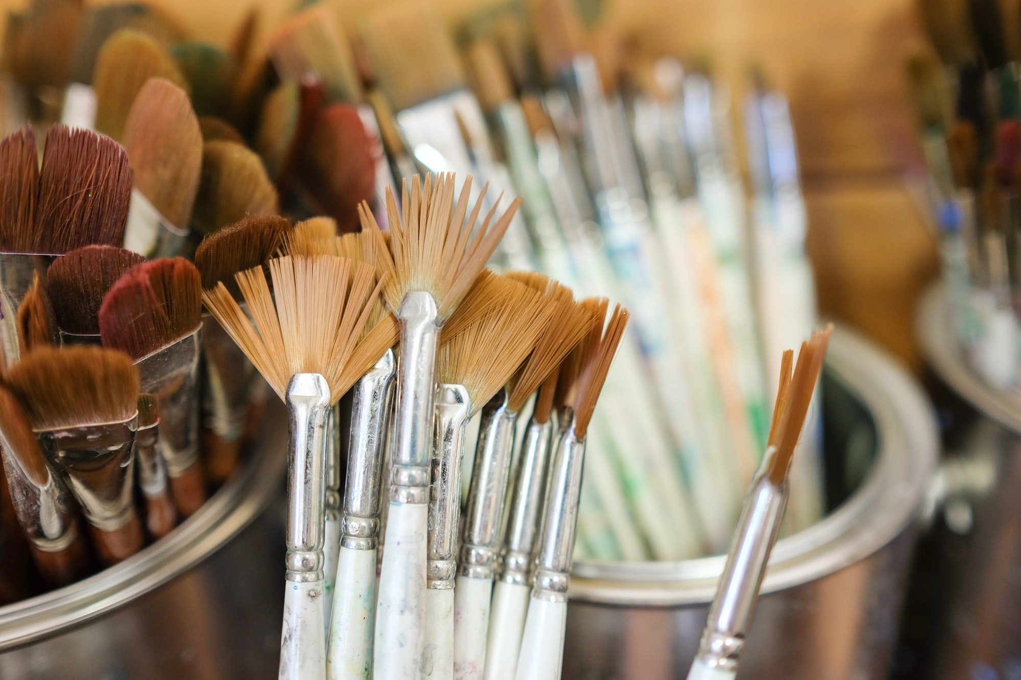 Paintbrushes and other art supplies in an art studio