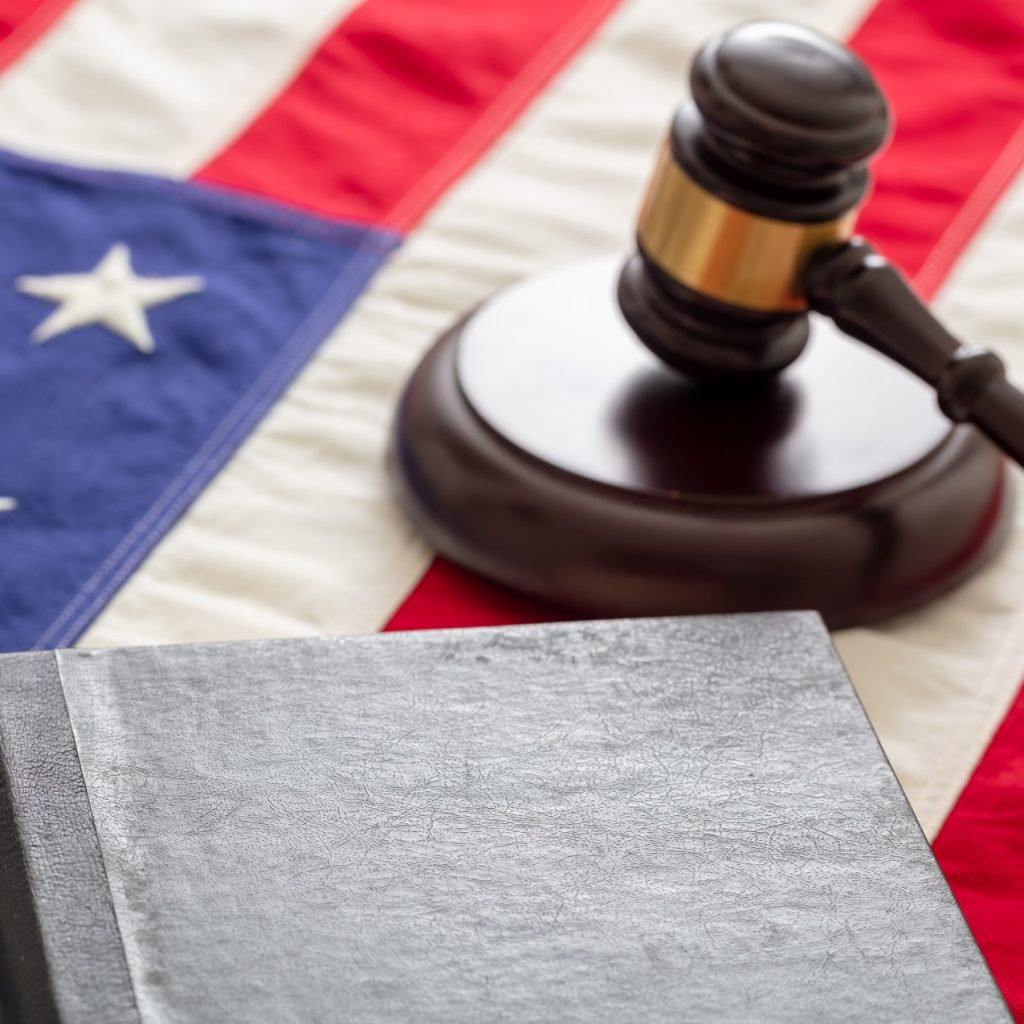 Law gavel and book on United States of America flag.
