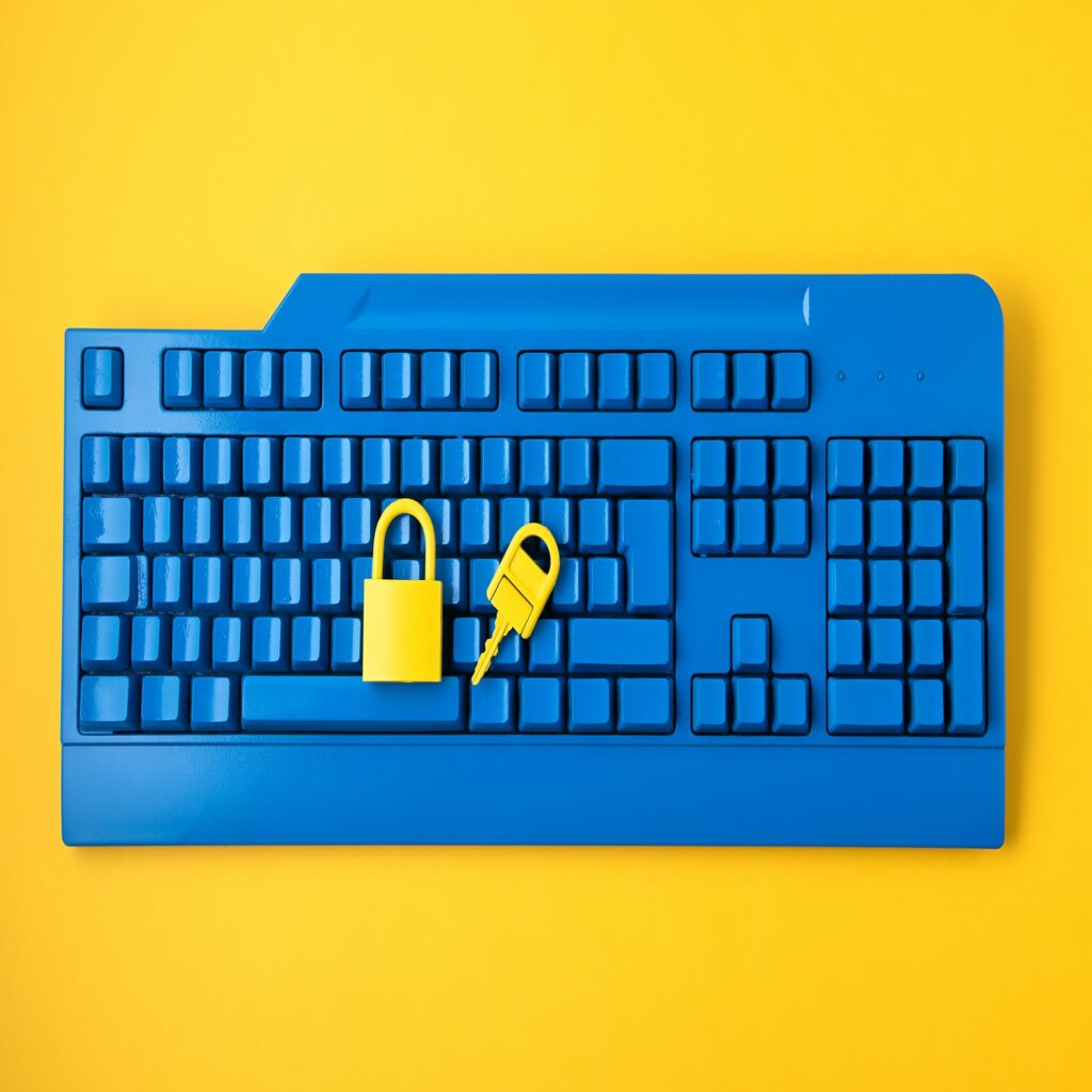 Cyber data and information security idea. Yellow padlock and key and blue keyboard. Computer