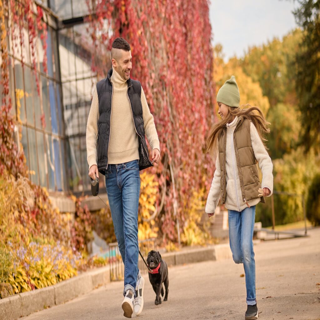 A man and a girl running with a dog